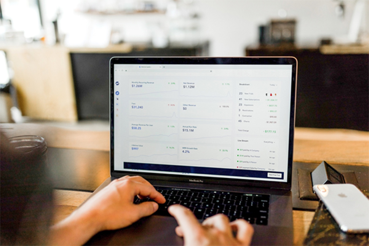 person typing on computer with RFP logistics growth display